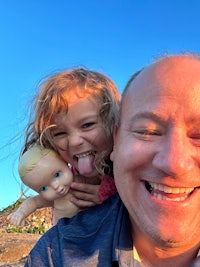 a man with a little girl holding a doll