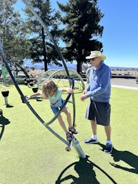 a man and a child playing on a playground