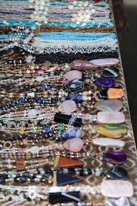 a display of necklaces hanging on a wall