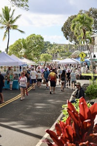 a crowd of people walking down a street