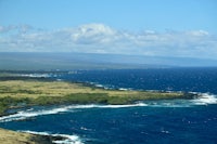 a view of the ocean from the top of a hill